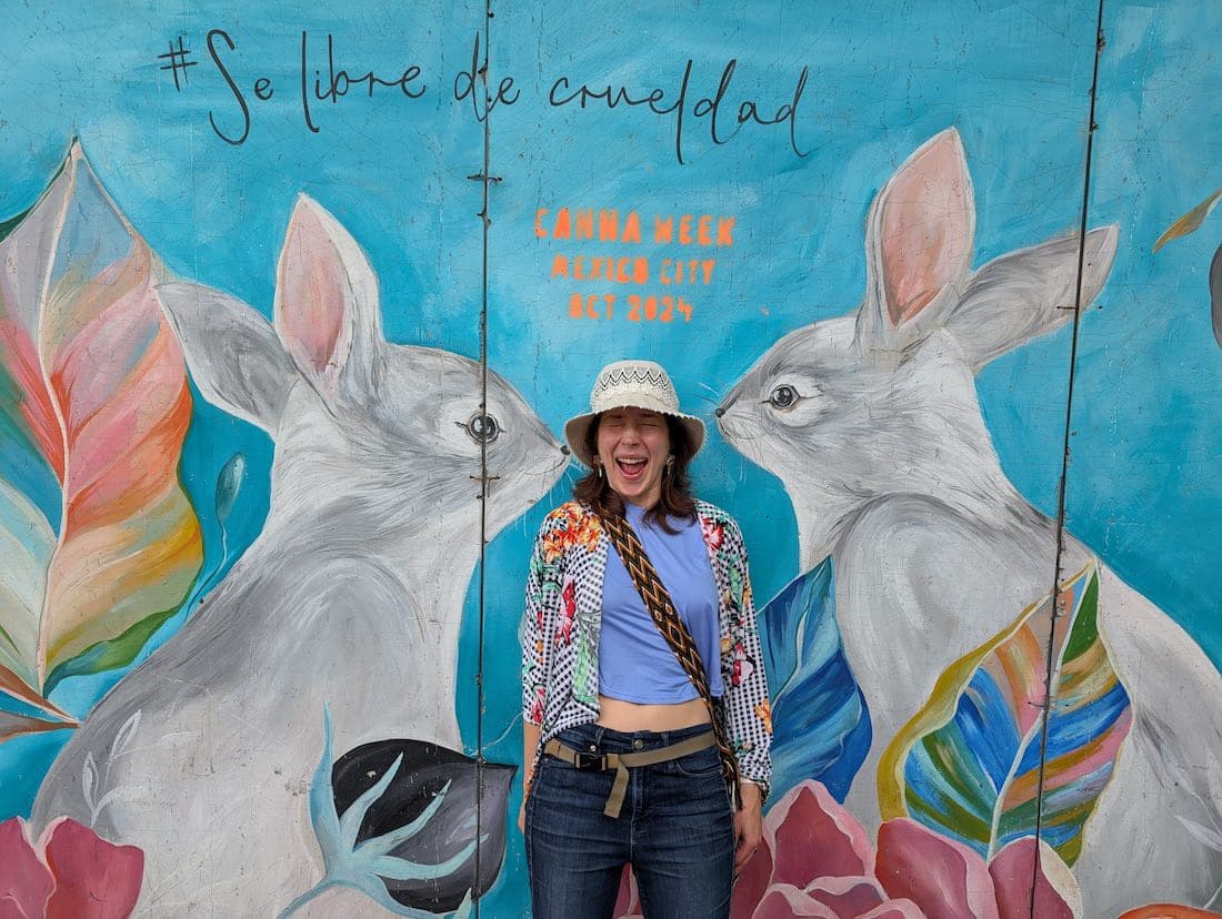 Olya standing in front of a mural